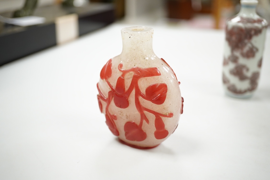 A Chinese cinnabar lacquer snuff bottle, a glass overlay snuff bottle and an underglaze copper red snuff bottle-9cm high (3)